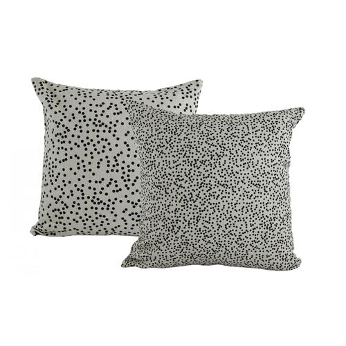 A 100% cotton powder grey cushion with a small black spot print on one side, and a more spaced out black spot print on the reverse. 